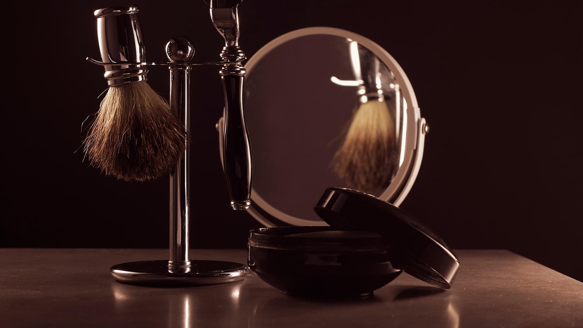 Shaving brushes and a razor on a grooming stand